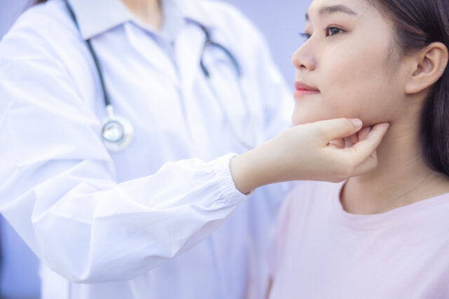 Doctor examining a patient's neck