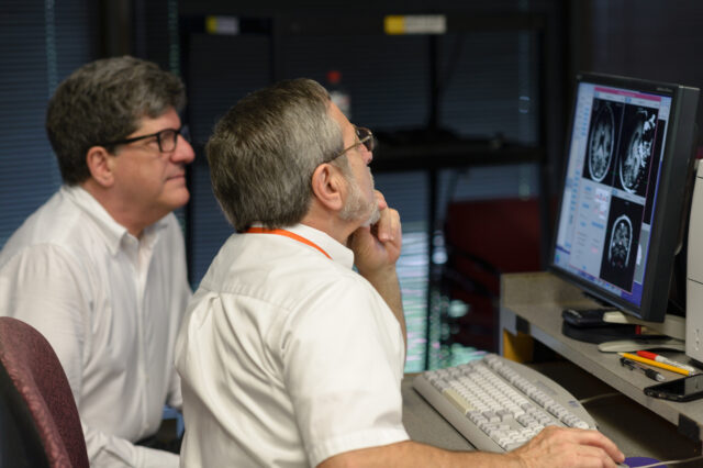 Two UF Health doctors looking at a computer screen