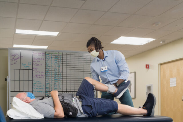 Fixel Institute doctor working a patient's knee