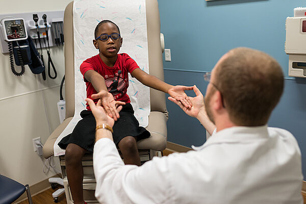 Doctor holding pediatric patient's hands