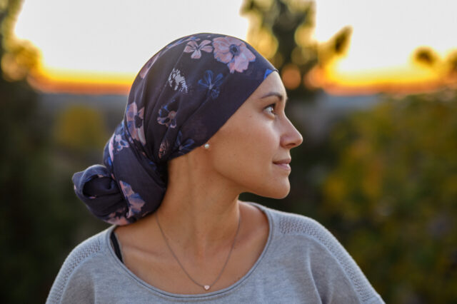 woman wearing head scarf and looking at the sun