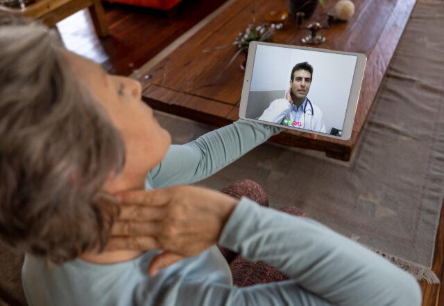 woman talking to doctor on tablet