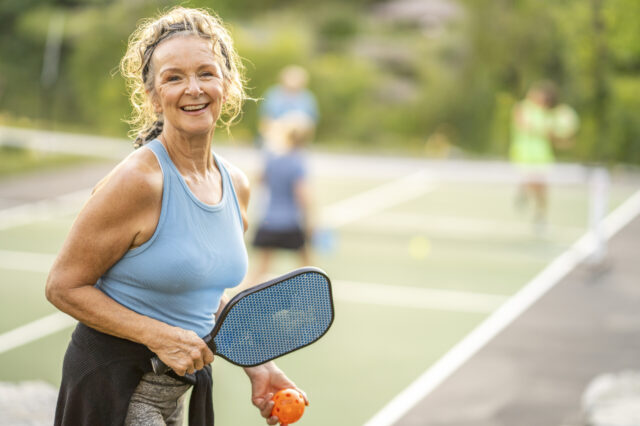 Woman playing pickleball on a court
