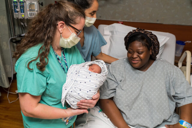 Nurse showing a patient her baby