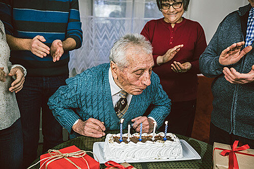 Man blowing out birthday candles