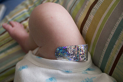 baby's leg with a bandaid