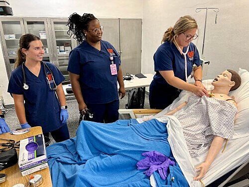Accelerated Bachelor of Science in Nursing students work on a simulation mannequin during a clinical lab. File Photo