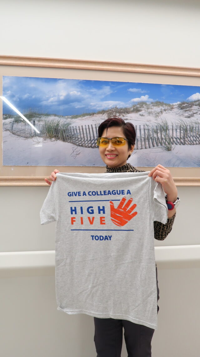 Bernadette Gloria, RN, received a High Five T-shirt for receiving the most High Fives from colleagues. She wears it to encourage others to recognize a co-worker.