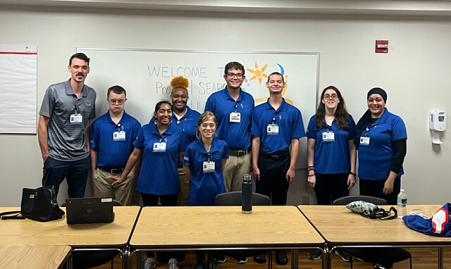 Eight Alachua County Public Schools students and one instructor posing for a group photo as the first Project SEARCH intern class at UF Health Shands Hospital in 2023.