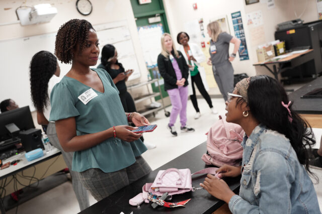 UF College of Nursing assistant professor Lakeshia Cousin speaks with an Eastside High School senior during a nurse mentorship program session last year.﻿