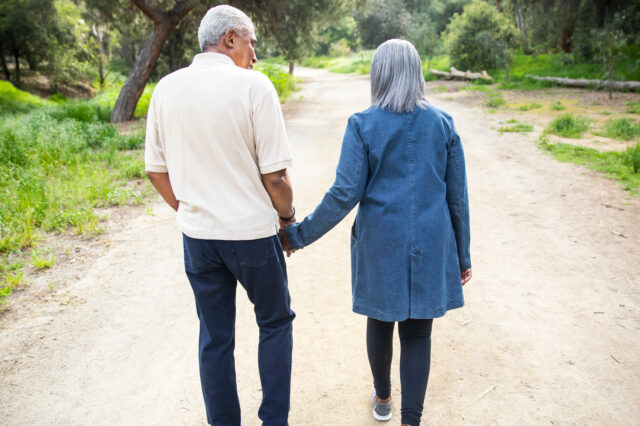 Two people walking and holding hands