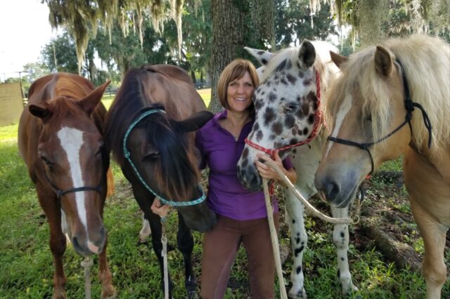 Lisa with four different colored horses