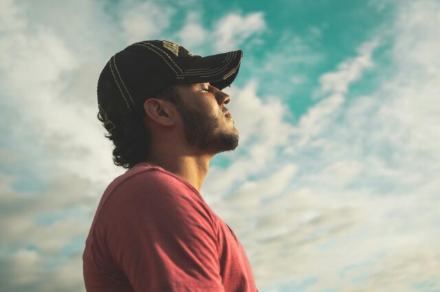 Man looking at sky and breathing in
