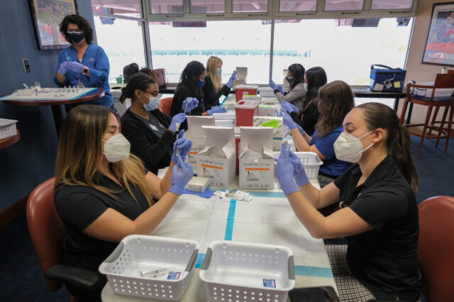 UF College of Pharmacy faculty and students prepare vaccine doses to support vaccination efforts on campus and in our community.
