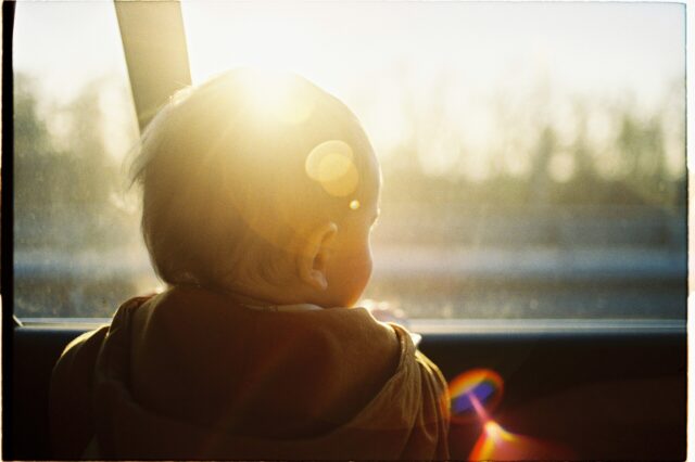 Small child looking out car window
