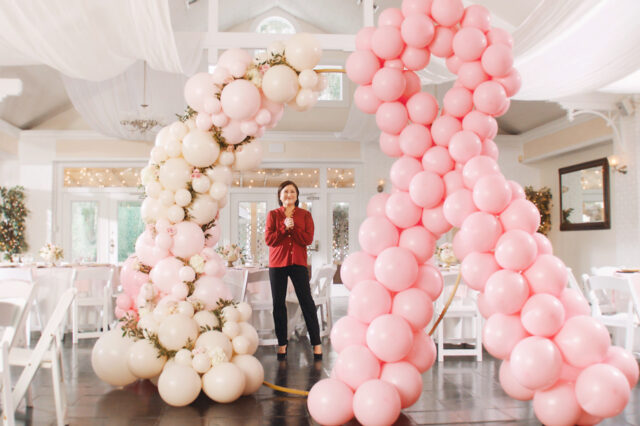 Courtney surrounded by pink balloons