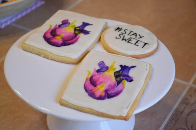 sugar cookies painted by Melanie featuring an abstracted heart in pretty pinks and purples. One of the cookies says stay sweet on it.