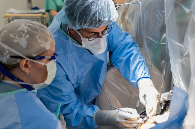 Two physicians perform a deep brain stimulation procedure.