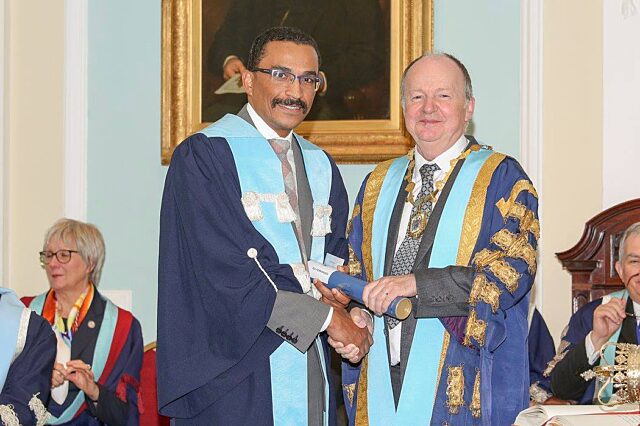 Rui Fernandes, M.D., D.M.D., receives and award and looks super happy