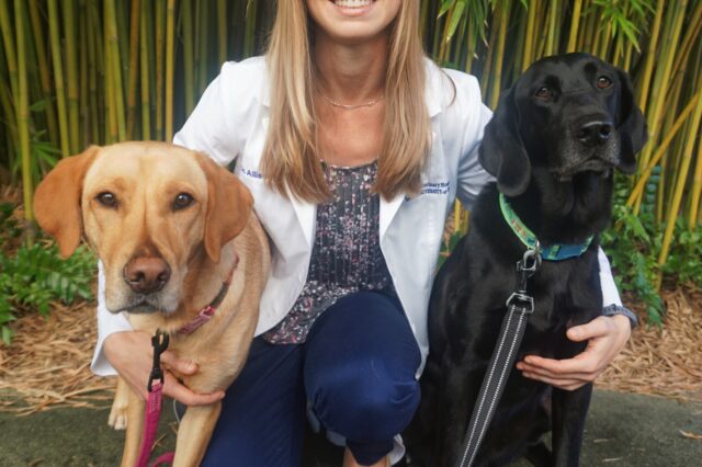Woman posing with two dogs