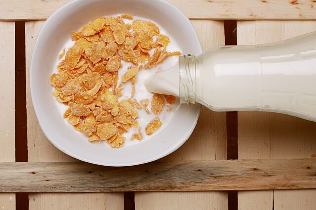 Pouring Milk Into Bowl Of Cereal Stock Photo - Download Image Now
