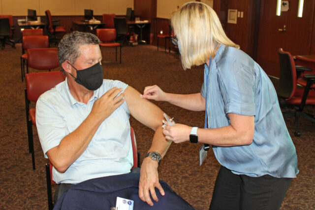 David R. Nelson, M.D., senior vice president for health affairs at UF and president of UF Health, gets his flu vaccine