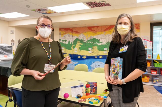 Physicians stand with the new coping kits created for pediatrics patients