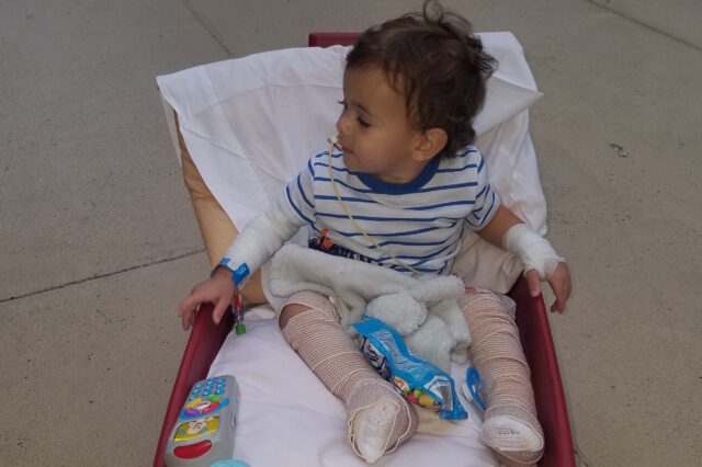 A photo of Kash Hill in an infant's wheeled device