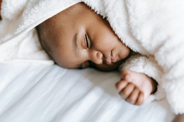 Baby sleeping with white blanket