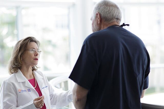 UF Health Proton Therapy Institute medical director doctor Nancy Mendenhall talking with a patient