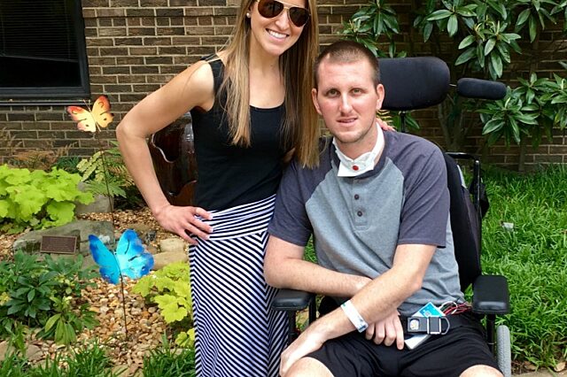 Man in a wheelchair and woman posing for a photo