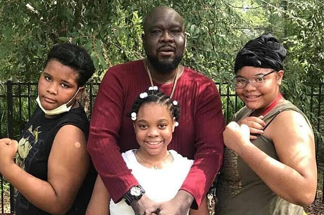 Akeem Thompson Sr. and his kids after getting vaccinated