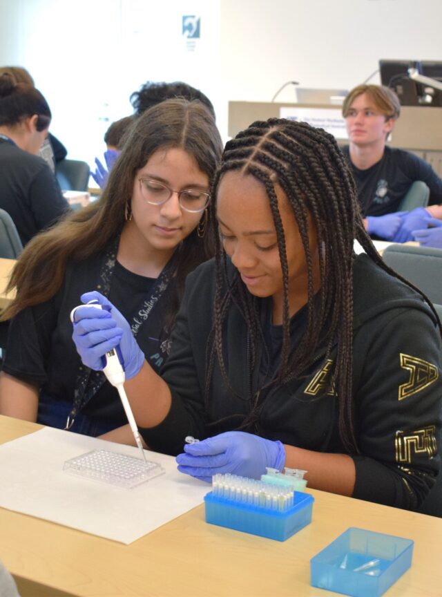 Students from Emerald Cove Middle School’s Pre-IT Academy conduct a drug discovery simulation during a recent field trip to the institute. Pictured are Silvanna Salazar and Jalyssa Vaccianna. A new gift from the Glenn W. Bailey Foundation supports expansion of such education outreach efforts.