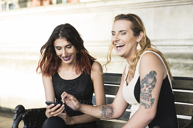 Transgender person laughing with a friend
