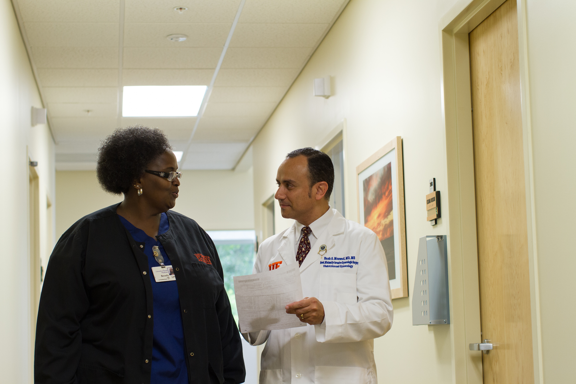 Nash Moawad, M.D., speaking with a fellow staff member.