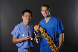 Stanley Kim, B.V.Sc., left, an associate professor of small animal surgery at the UF College of Veteri ary Medicine, and Adam Biedrzycki, B.V.Sc., Ph.D., an assistant professor of large animal surgery at the college, use the 3-D printer to develop bone models that “actually feel and handle like the real thing” during presurgery practice. Photo by: Mindy Miller