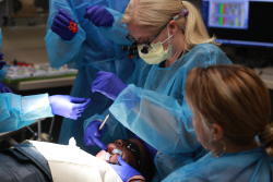 Ashley Daniels, D.D.S., a second-year pediatric dentistry resident at the NCEF Pediatric Dental Center in Naples, provides care for a patient in November 2019. This image was taken prior to national guidelines of face coverings and social distancing. (Photo by Aaron Daye, UF Foundation)