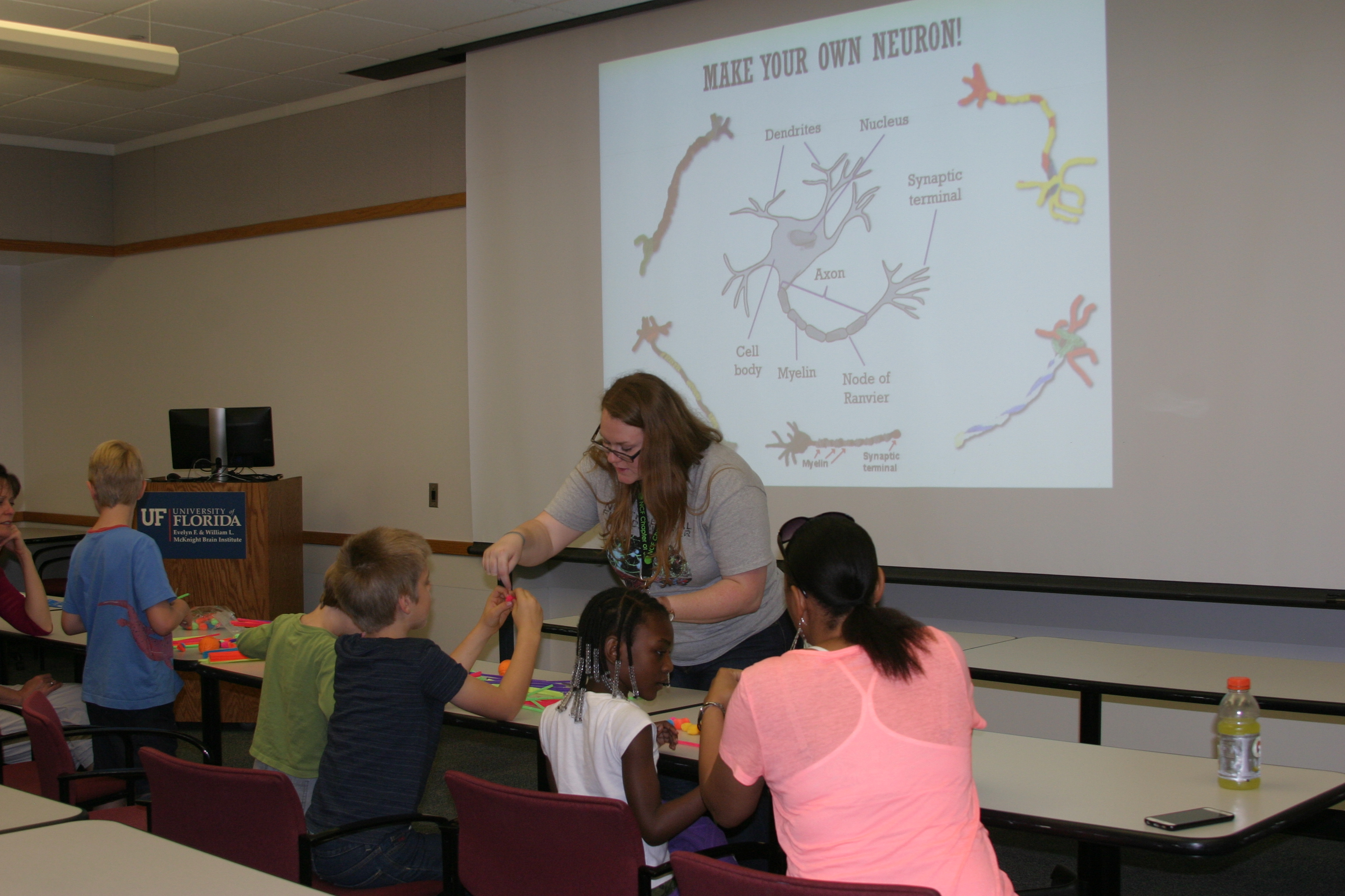 UF doctoral student Nicola Rutherford helps area homeschooled children make models of neurons.