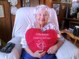 Rosalie Youngerman, 89, relaxes in the comfort of her home with a pillow she received signed by the cardiovascular team at UF Health. Photo by Rossana Passaniti