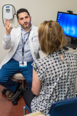 Ali Ataya, M.D., director of the UF Health HHT Center of Excellence, meets with a patient recently. HHT, or hereditary hemorrhagic telangiectasia, is a malformation of blood vessels that can cause dangerous bleeding.