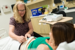 UF researcher Charlene Krueger assesses the heart rate of Kimberly Mahoney’s baby during her third trimester of pregnancy.