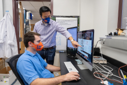 Dr. Liang Zhou and his graduate student, Joseph Dean, review recent findings published by their lab relating to the protein Ahr. (Photo by Jesse Jones)