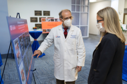 Paul Okunieff, M.D., Ph.D., professor and chair in the department of radiation oncology, discusses the Elekta Unity MR-Linac with Traci d’Auguste, chief operating officer for UF Health, during a groundbreaking ceremony at the UF Health Davis Cancer Pavilion on Thursday, July 21.