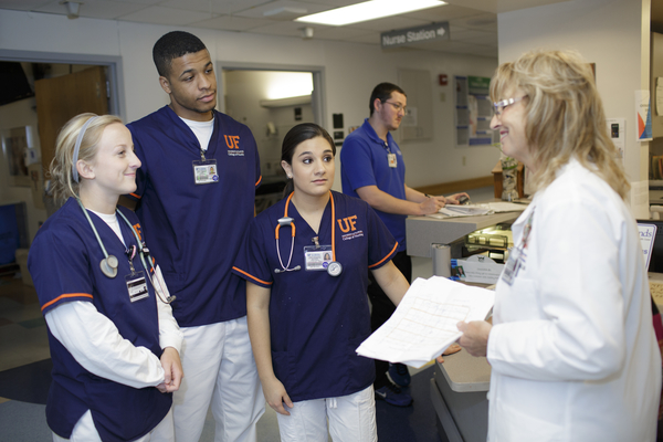 College of Nursing faculty member Bonnie Carlin helps orient students to a unit at UF Health Shands Hospital, where they are in clinical rotations.