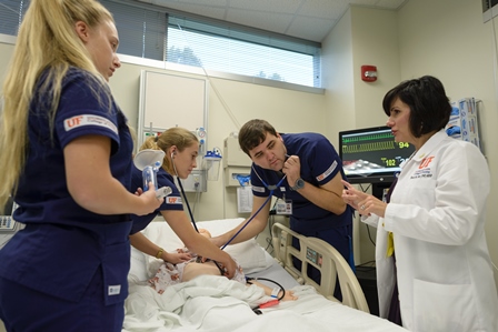 College of Nursing faculty member Stacia Hays instructs students using a simulated pediatric patient in the Nursing Resource Center.