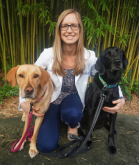 Allison O'Kell, D.V.M., with her two dogs.