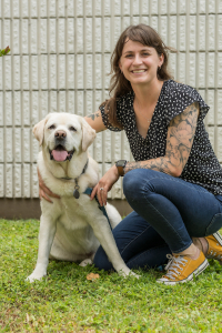 Third-year University of Florida veterinary student Maggie Smallwood is shown with her 7-year-old yellow Labrador retriever, named Leo. Leo received the first total ankle replacement surgical procedure performed on a dog in Florida in January at UF's Small Animal Hospital. (Photo by Louis Brems).