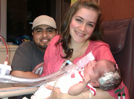 Krystina Lopez holds baby Izabella next to Izabella’s father, Jesus.