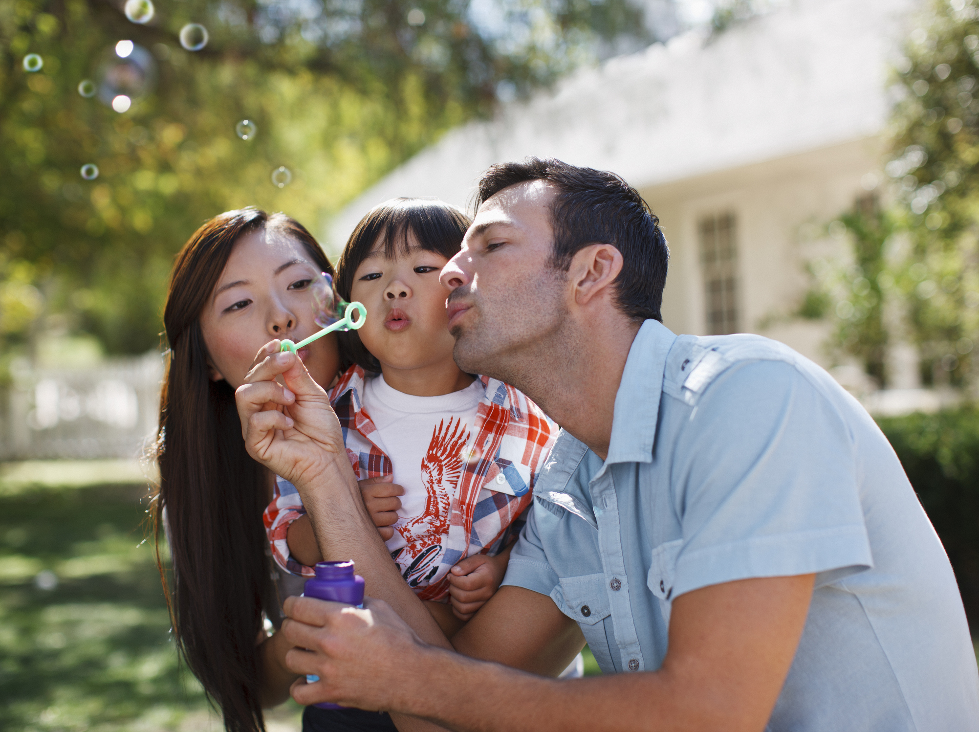 A young family blowing bubbles