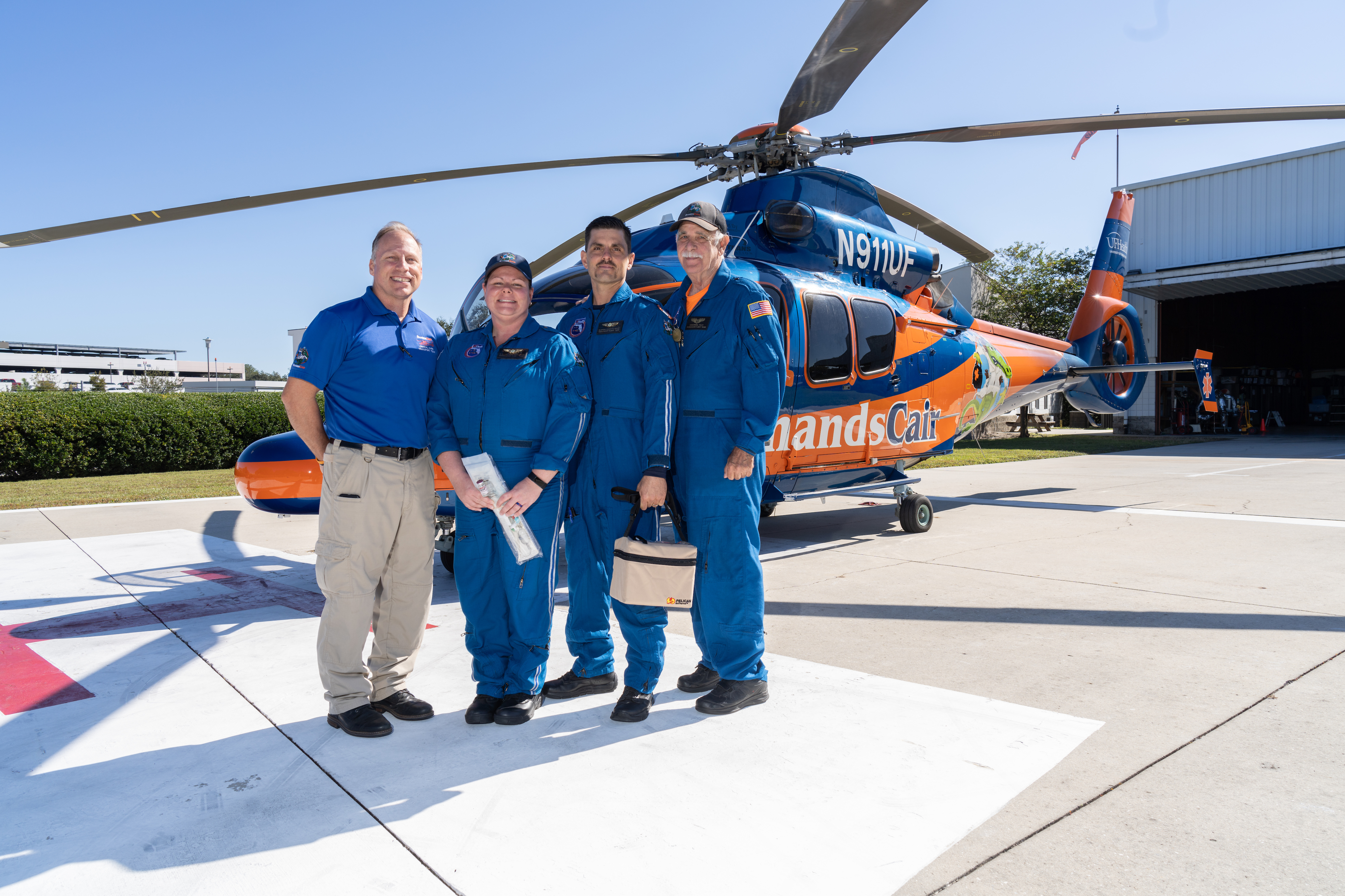 ShandsCair team of four people standing in front of a ShandsCair helicopter